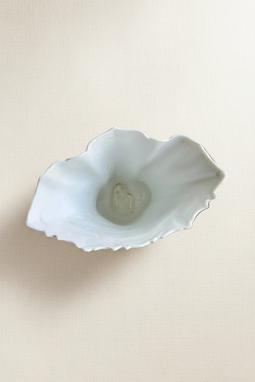Top-down view into the flared lip of a 19th-century Rococo Revival porcelain vase — white interior with scalloped rim and faint gilt edge detail, southern Germany c.1880