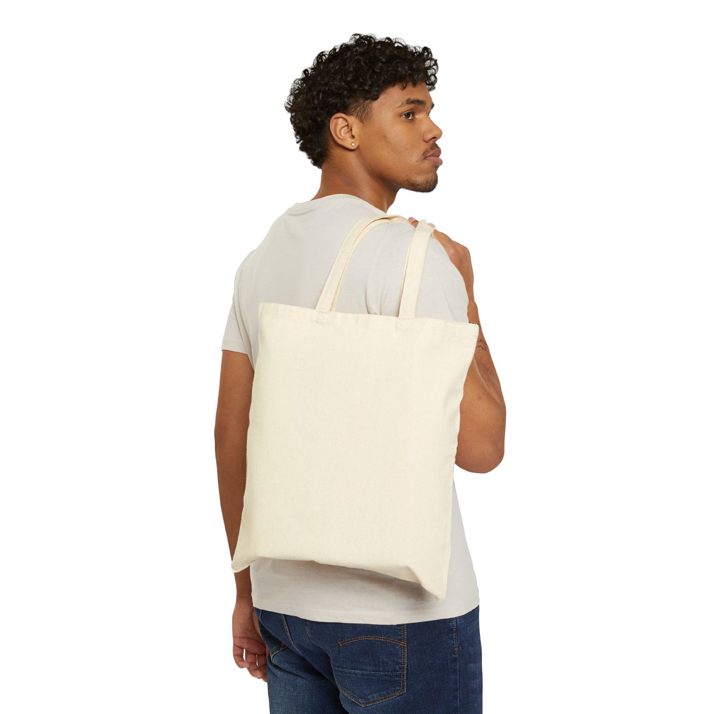 Cream cotton tote bag carried by a man, perfect for casual outings and eco-friendly shopping.