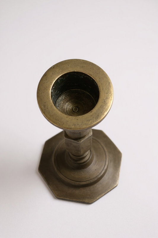 Brass candle holder on a white background