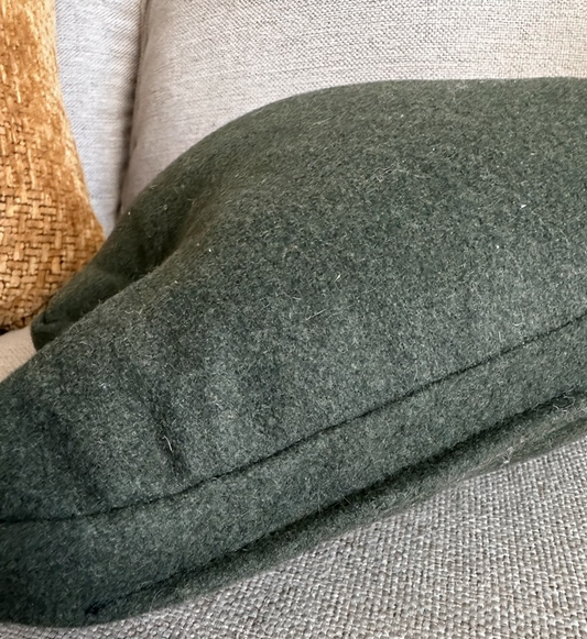 Green cushion on a textured gray sofa