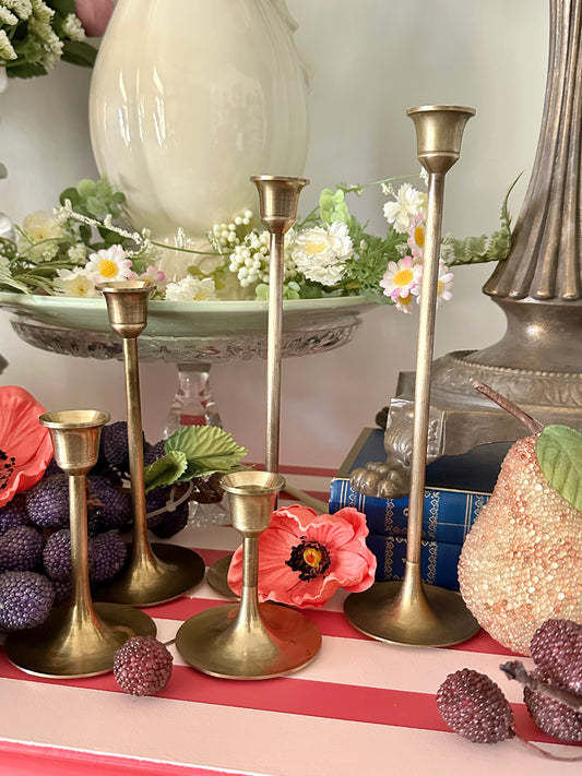 Decorative table setting with candle holders, flowers, and decorative items.