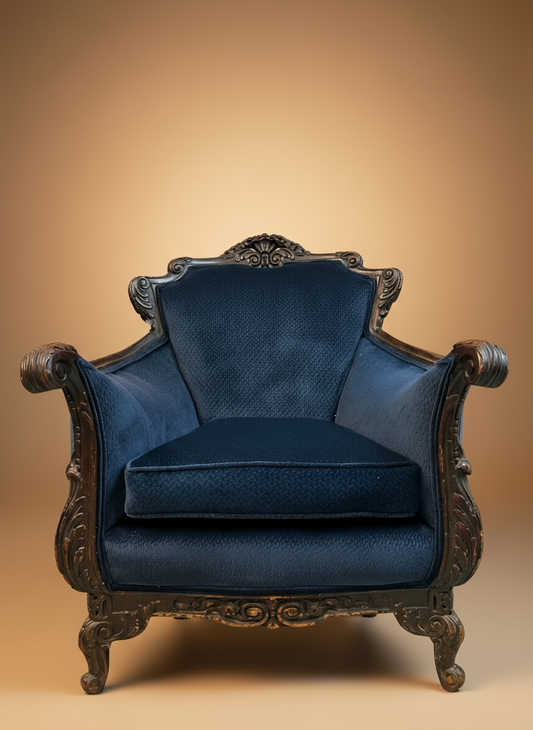 Blue upholstered armchair with ornate wooden frame on a beige background