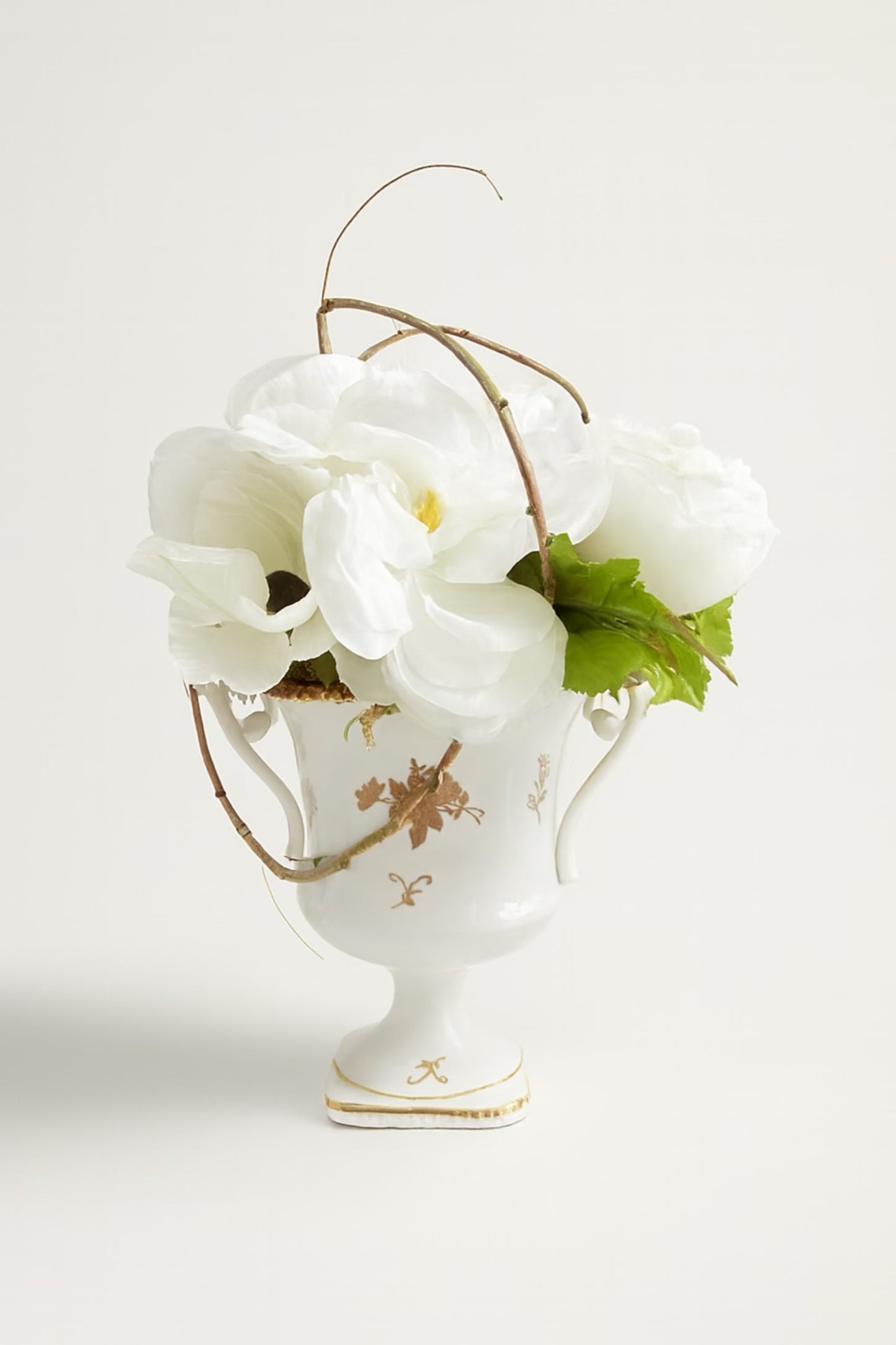 Vintage floral arrangement in urn white artificial flowers