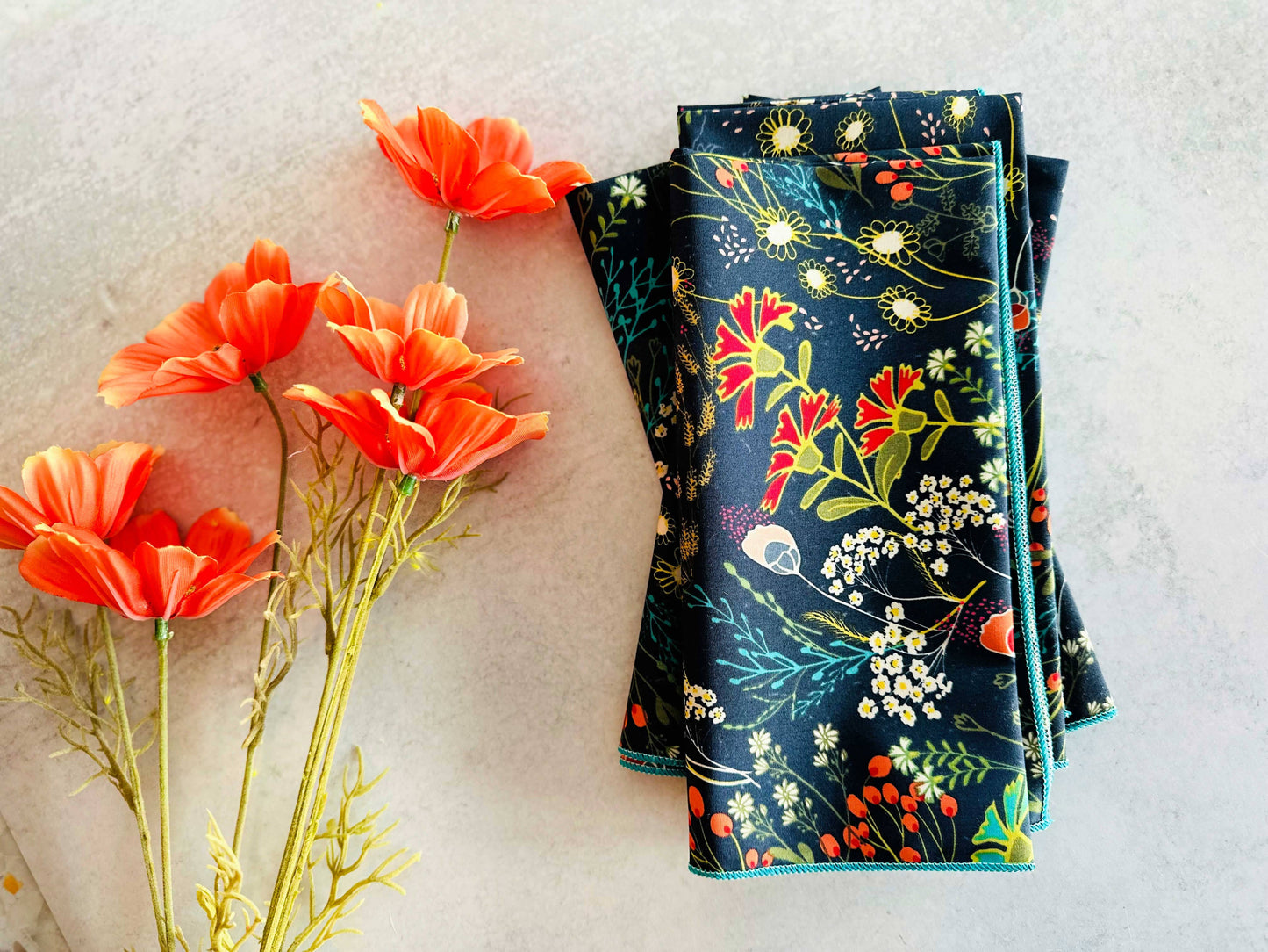 Floral-patterned fabric with red flowers on a textured surface