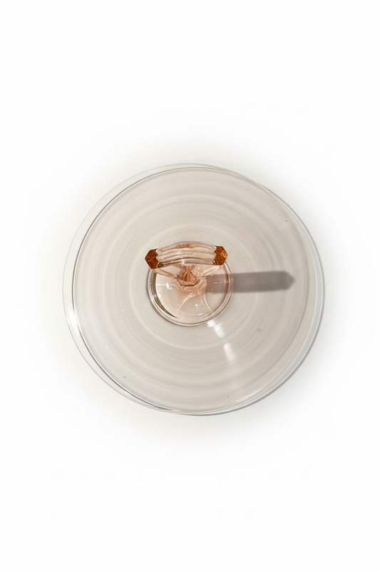 Overhead top down view of a circular ten inch pink Depression glass server showing the outer rim and center handle alignment.
