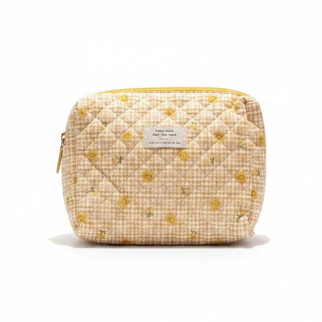 Floral-patterned pouch, croissant, and Chang lime soda on a white surface