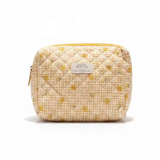 Floral-patterned pouch, croissant, and Chang lime soda on a white surface