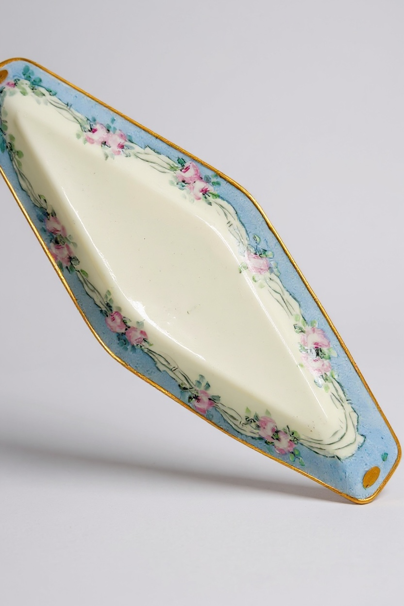 Ceramic flower dish, light blue with pink floral accents and gold trim, perfect for decorative use.