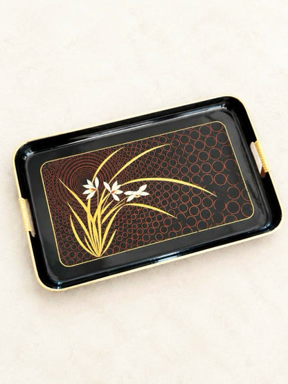 Vintage Japanese black lacquer serving tray with cream flowers, gold-tone leaves, red circular pattern, and cane handles.
