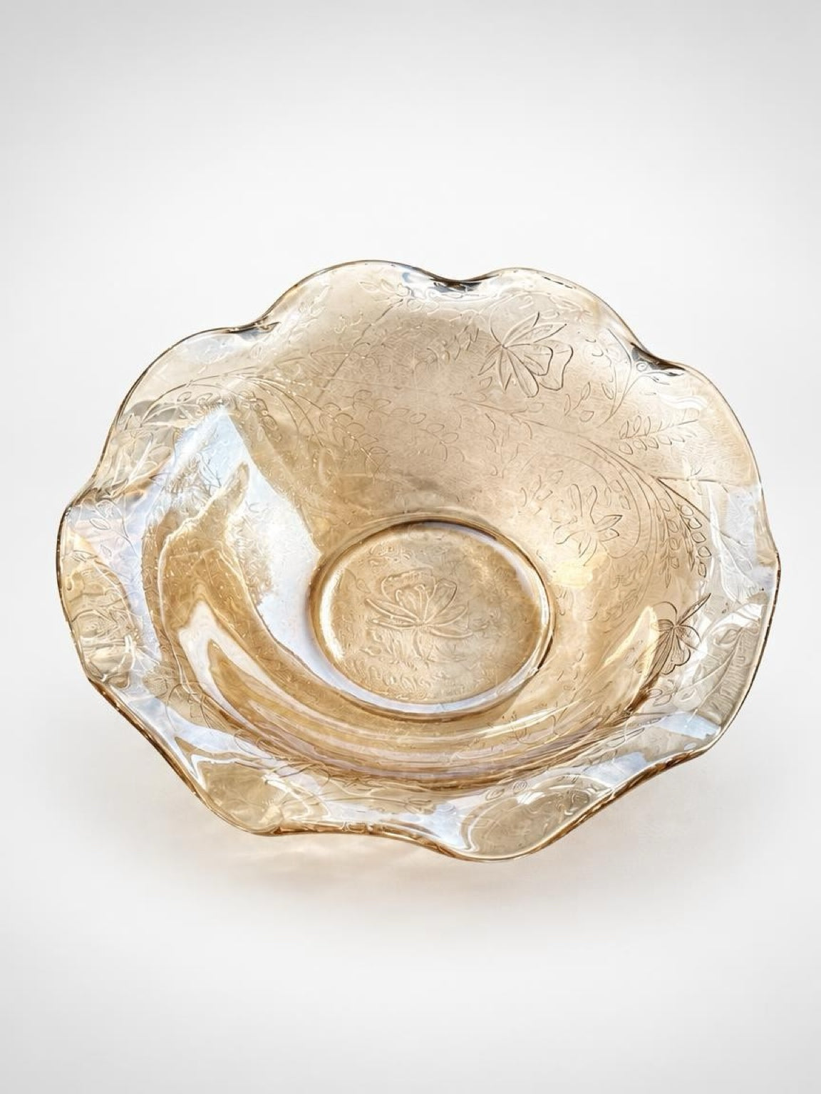 Overhead view of the Floragold bowl showing its wavy rim, molded botanical pattern, and floral center.