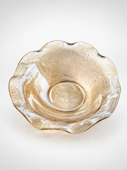 Overhead view of the Floragold bowl showing its wavy rim, molded botanical pattern, and floral center.