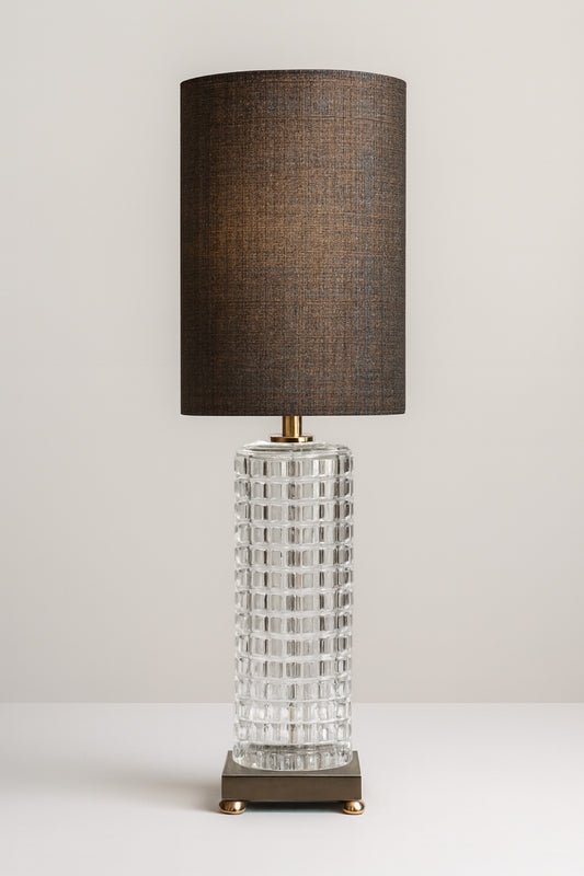 Black and gold table lamp with a textured glass base and modern metal platform, ideal for living room or bedroom lighting.