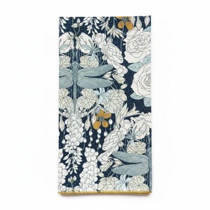 Single Dragonflies at Twilight napkin folded to show dragonfly motif detail, wisteria, and rose print on navy cotton with gold hem edge