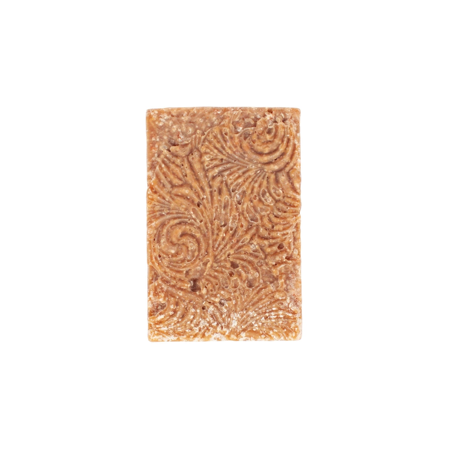 Handcrafted natural soap bar, light brown with intricate swirls, made from organic ingredients.