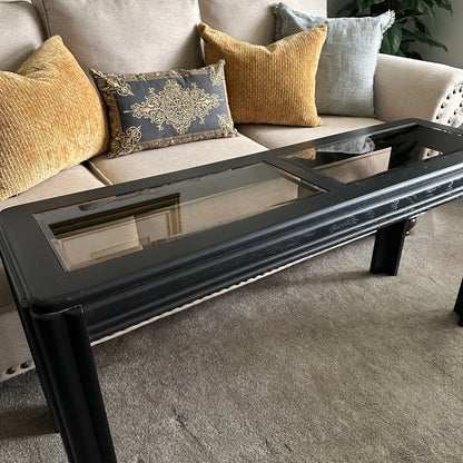 Side view of vintage black console table with fluted legs Featuring two glass table top panels