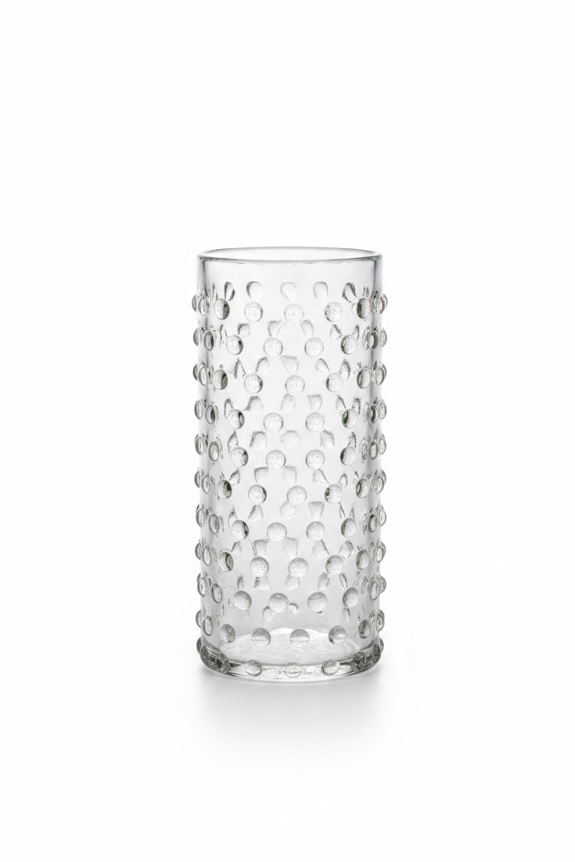 Set of 2 clear cylinder highball glasses with raised hobnail beaded texture sitting on a dark wooden tabletop, 6 inches tall.