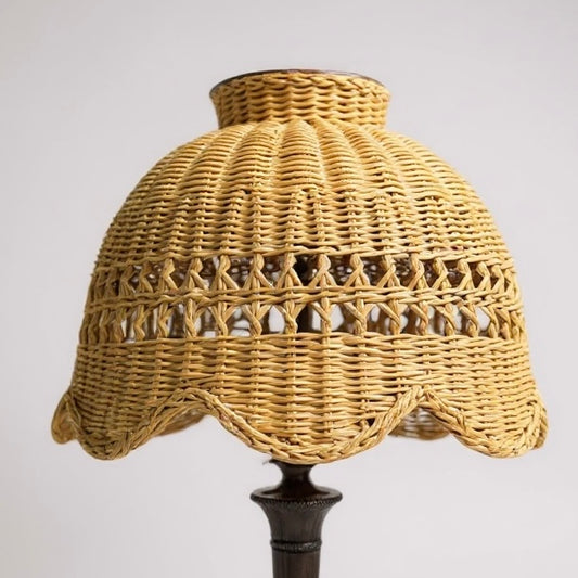 Handwoven wicker lamp shade in natural color with scalloped edges, perfect for home decor.