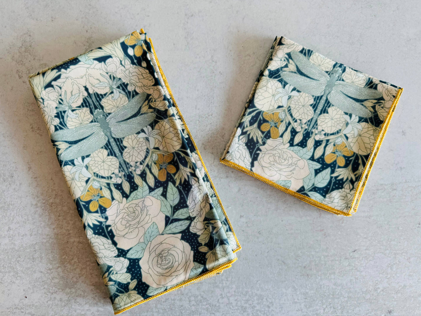 Two floral-patterned coasters on a light gray surface