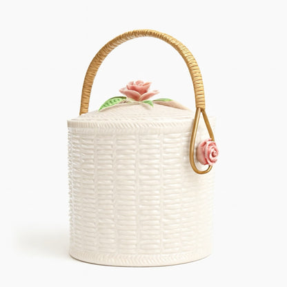Elegant white basket with pink rose lid and woven handle, perfect for decor or storage.