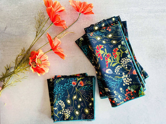 Floral cotton napkins in navy with vibrant spring designs, perfect for dining or decorating.