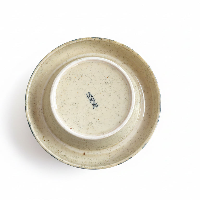 Ceramic container with a lid on a wooden surface