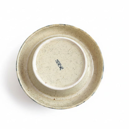 Ceramic container with a lid on a wooden surface