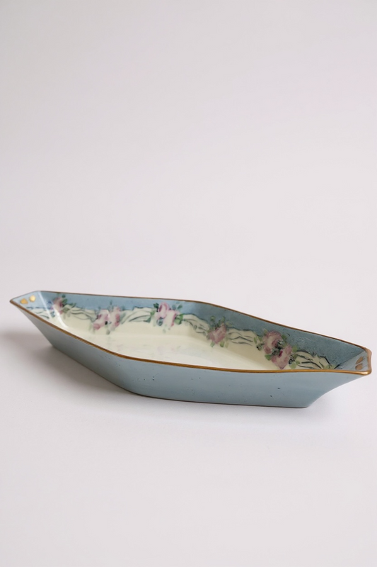 Decorative blue ceramic dish with floral design and gold trim, ideal for home decor or serving.