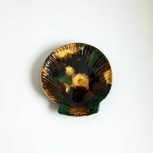 Decorative shell with brown, green, and black patterns on a white background