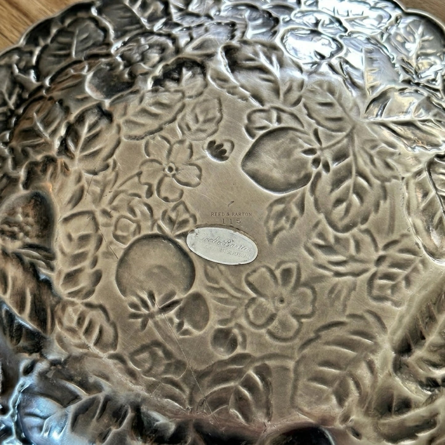 Authentic maker stamp and original foil retail label on the reverse side of a Reed and Barton 115 silver platter.