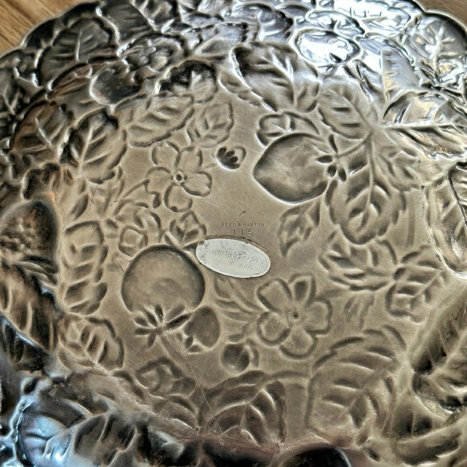 Authentic maker stamp and original foil retail label on the reverse side of a Reed and Barton 115 silver platter.
