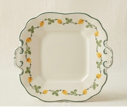 Decorative plate with floral pattern on a white background. The Susie Cooper "Delicate Blossoms" set is such a classic piece of design history.