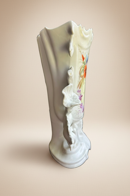 Side profile of antique German Rococo Revival porcelain vase c.1880 — white body with sculptural acanthus relief and hand-painted jewel-tone floral decoration visible at edge