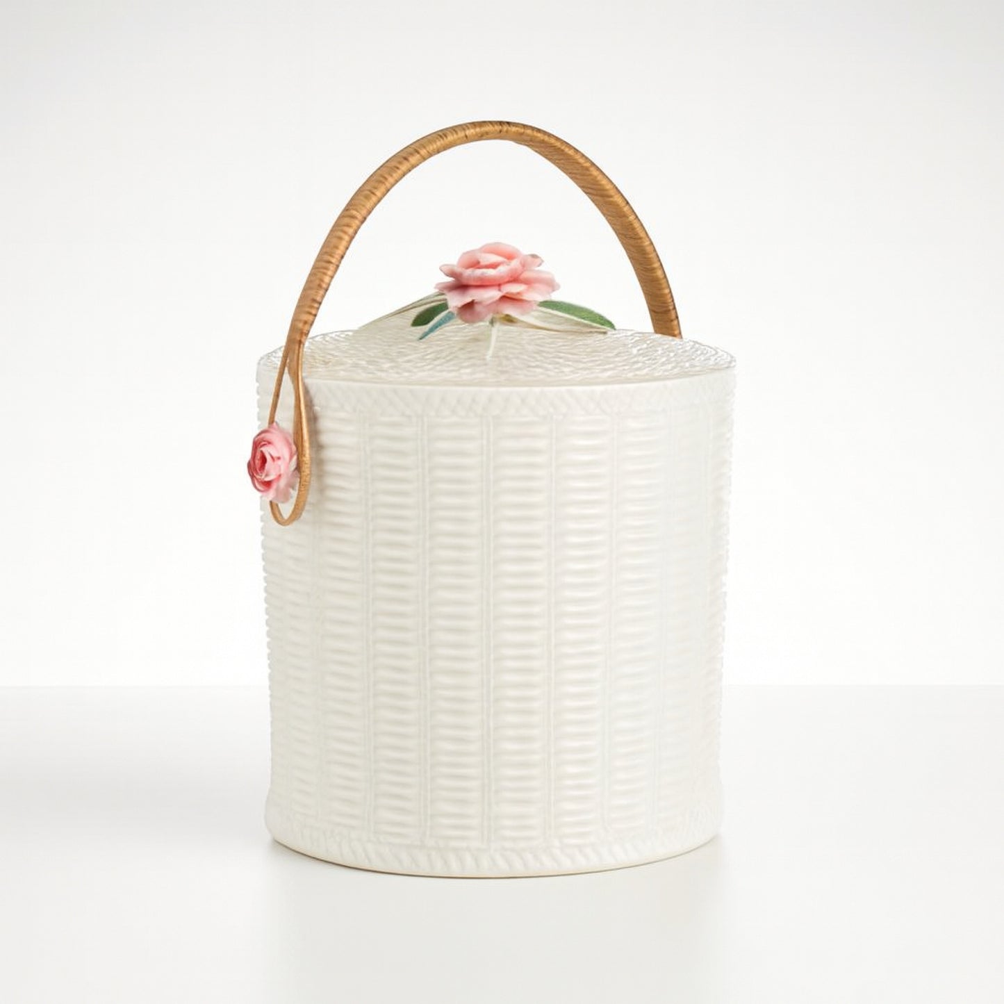 White decorative storage canister with a rose handle, intricate texture for home decor.