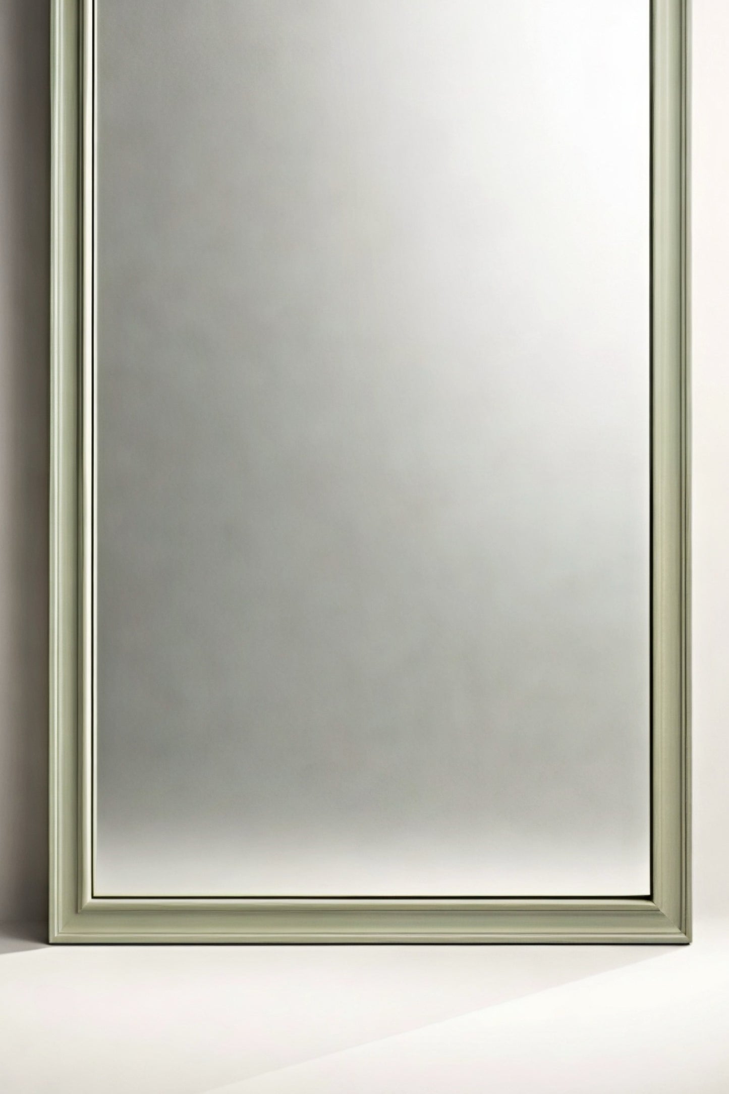 Elegant rectangular mirror with a soft green frame, perfect for modern home decor.