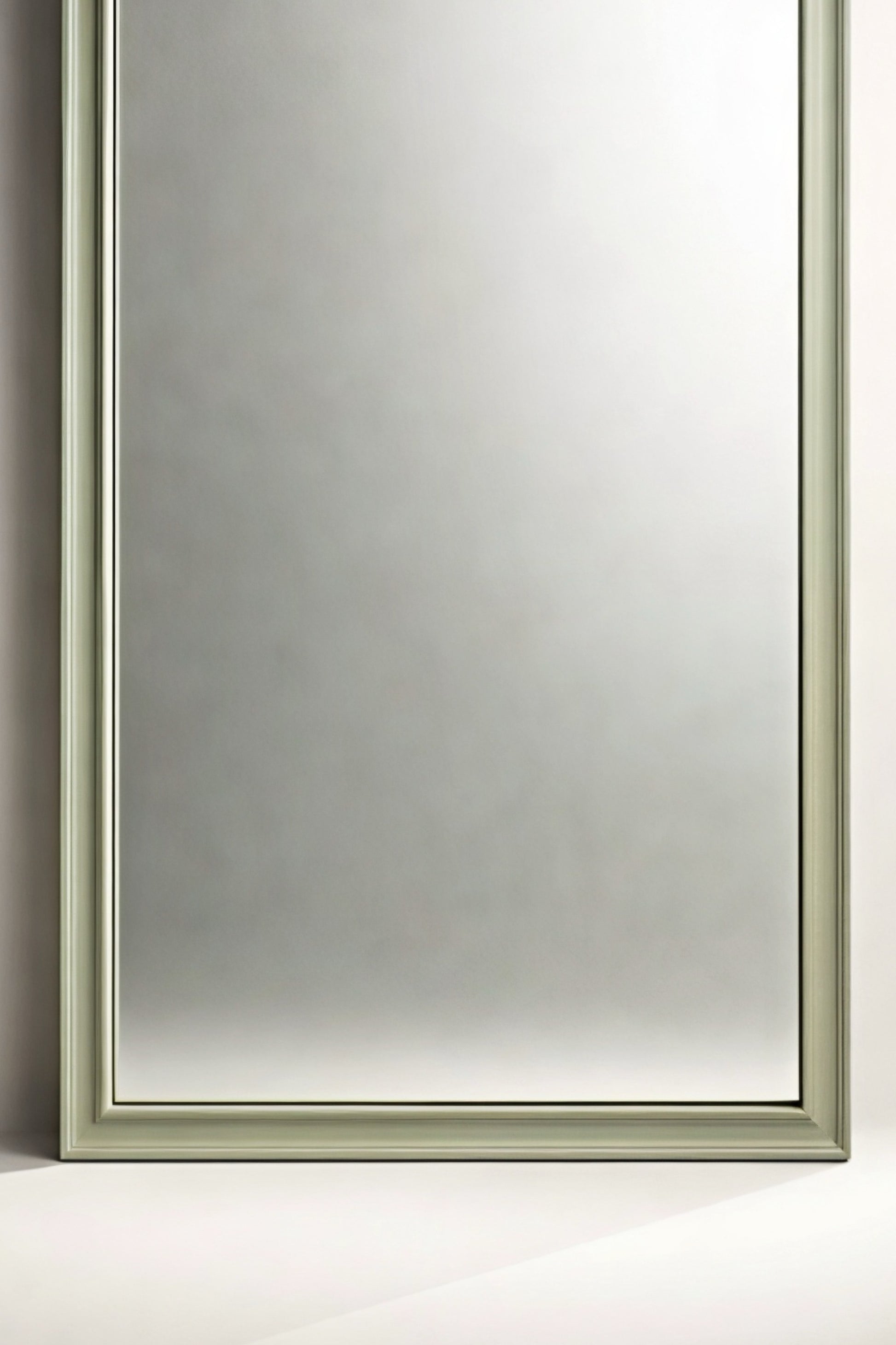 Elegant rectangular mirror with a soft green frame, perfect for modern home decor.