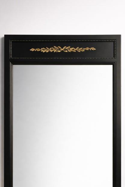 Elegant black wall mirror with gold leaf detailing, perfect for stylish home decor.