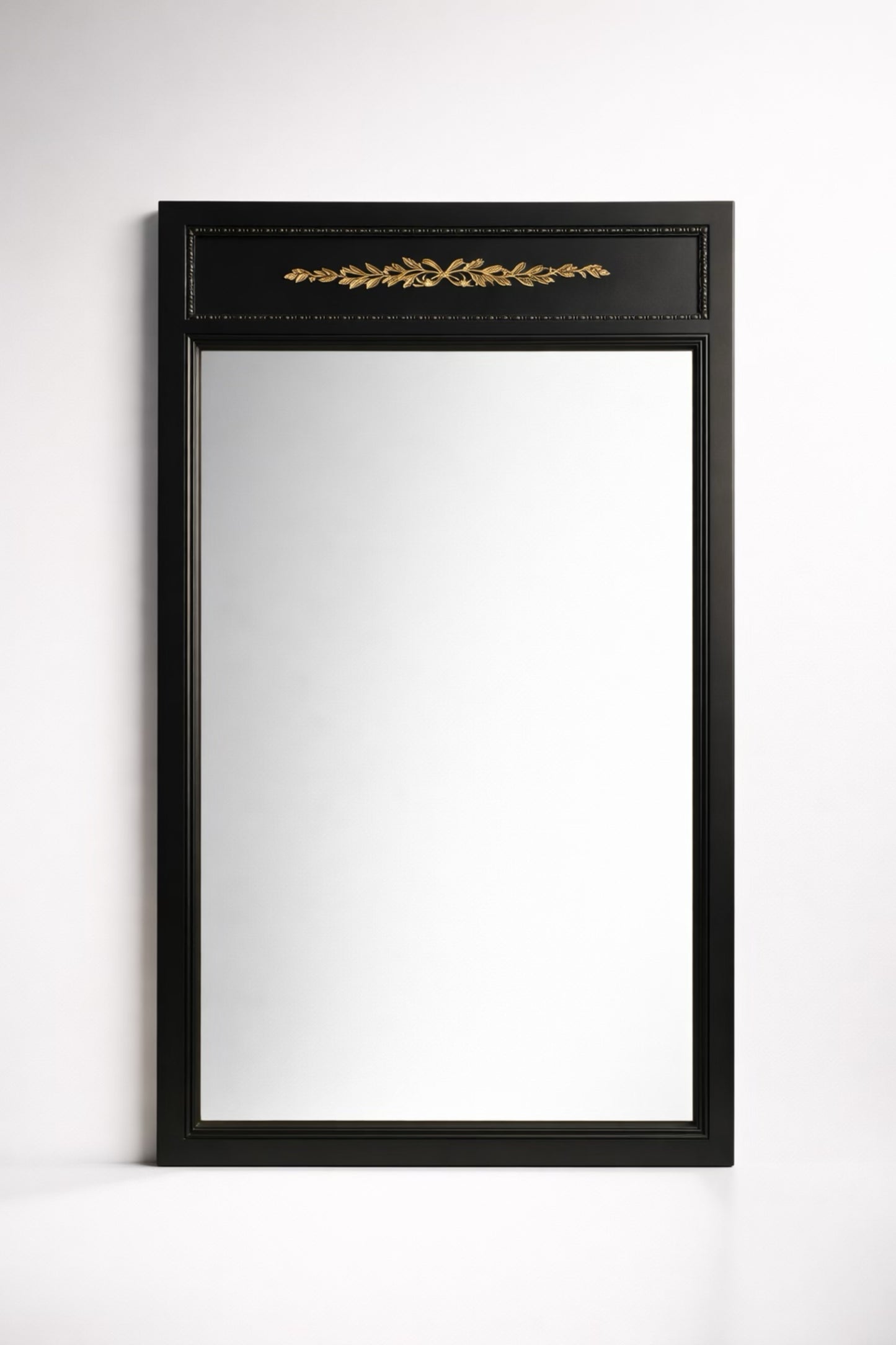 Elegant black framed mirror with gold leaf detailing, perfect for home decor.