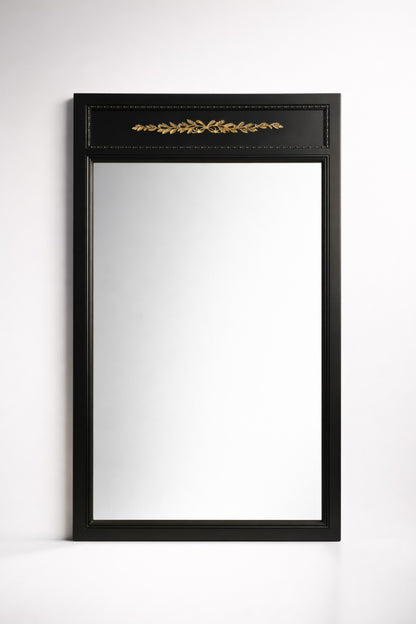 Elegant black framed mirror with gold leaf detailing, perfect for home decor.