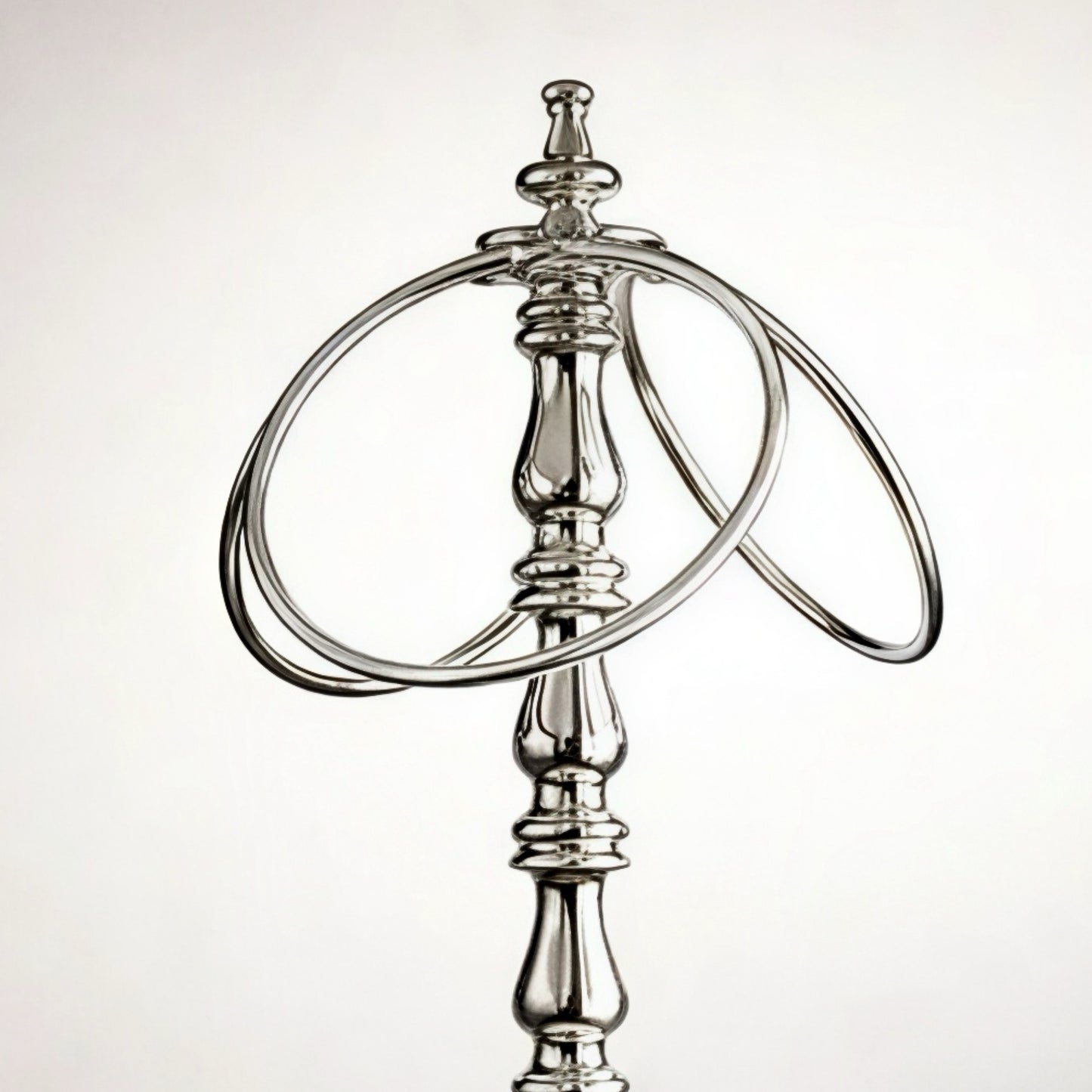 Elegant silver metal bottle holder with dual rings for stylish presentation.
