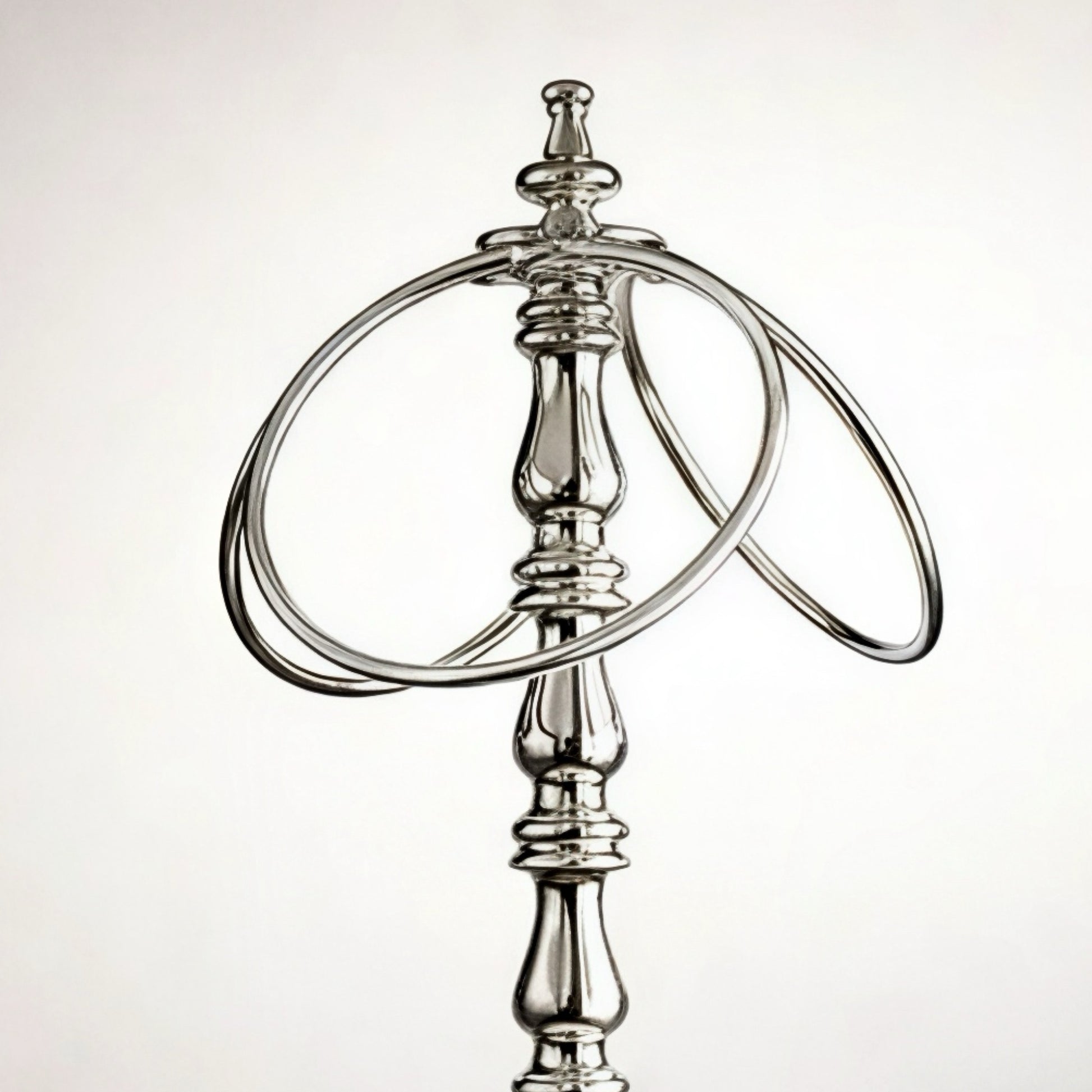 Elegant silver metal bottle holder with dual rings for stylish presentation.