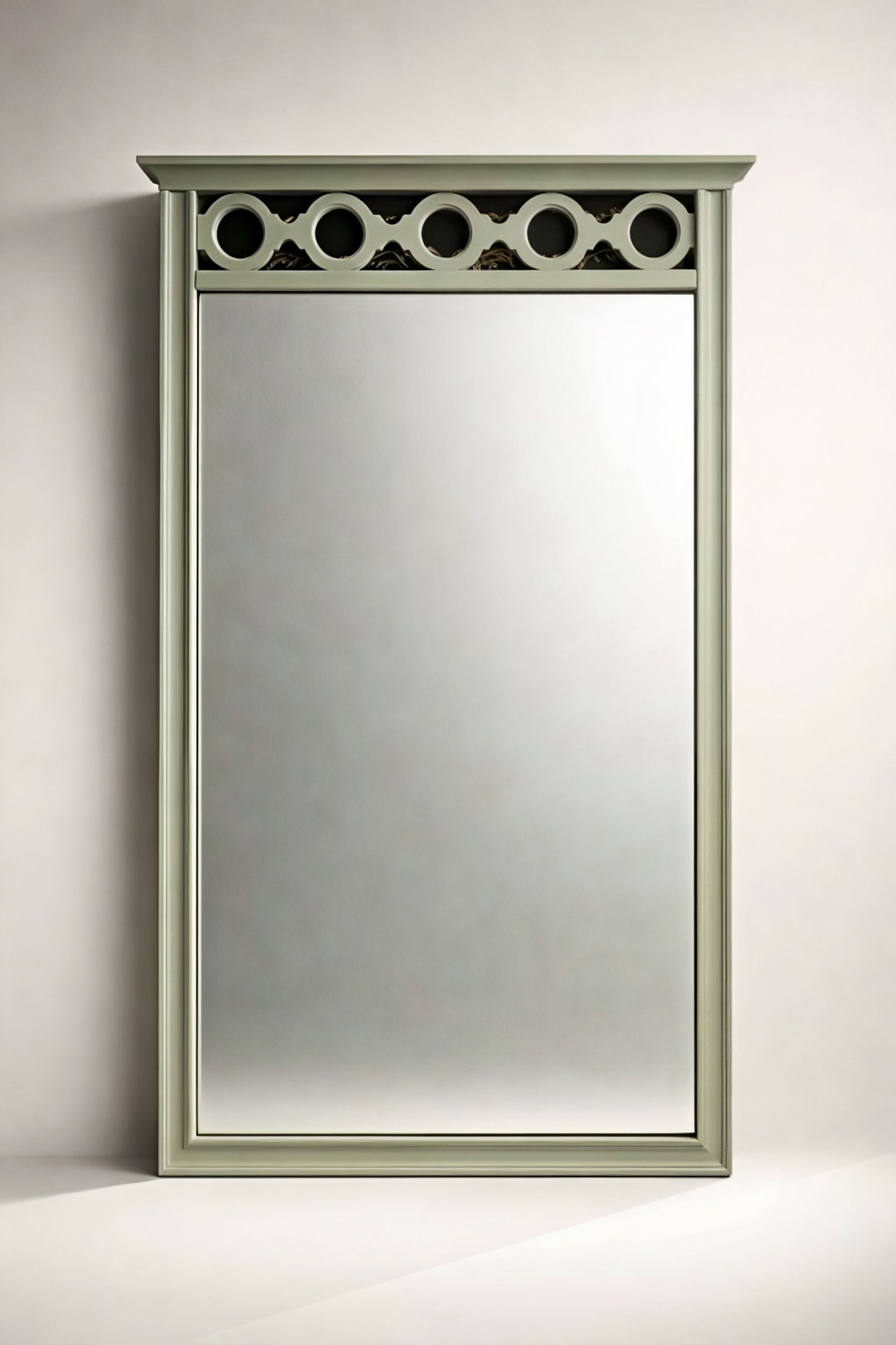 Elegant rectangular mirror with a light green frame and decorative top detailing, ideal for home decor.