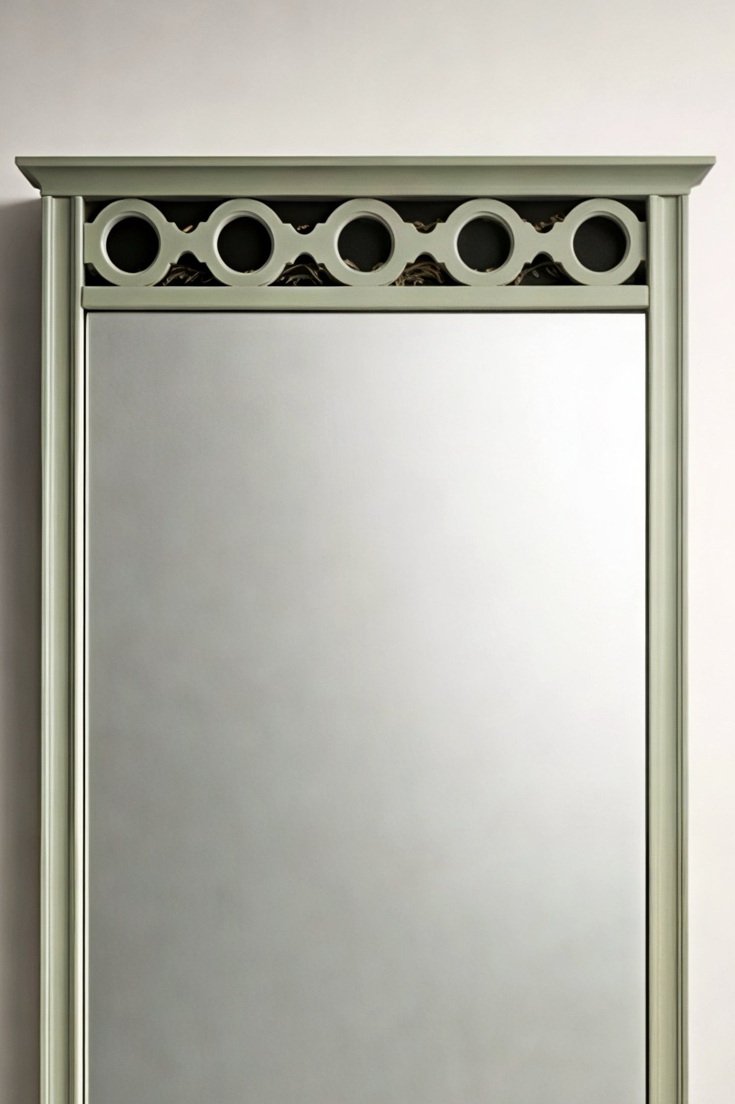 Elegant green decorative wall mirror with circular top detail, perfect for enhancing any room's decor.