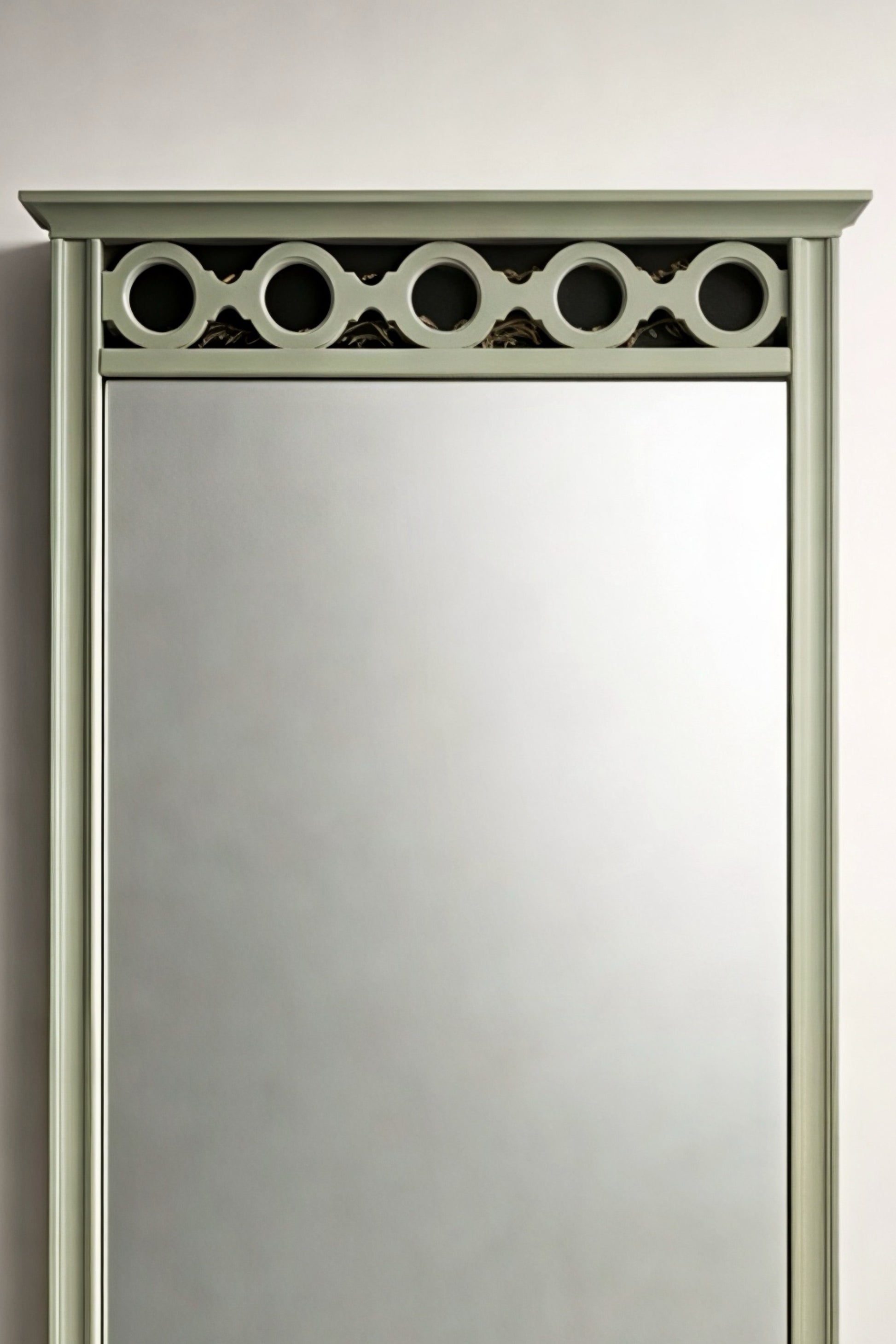 Elegant green decorative wall mirror with circular top detail, perfect for enhancing any room's decor.