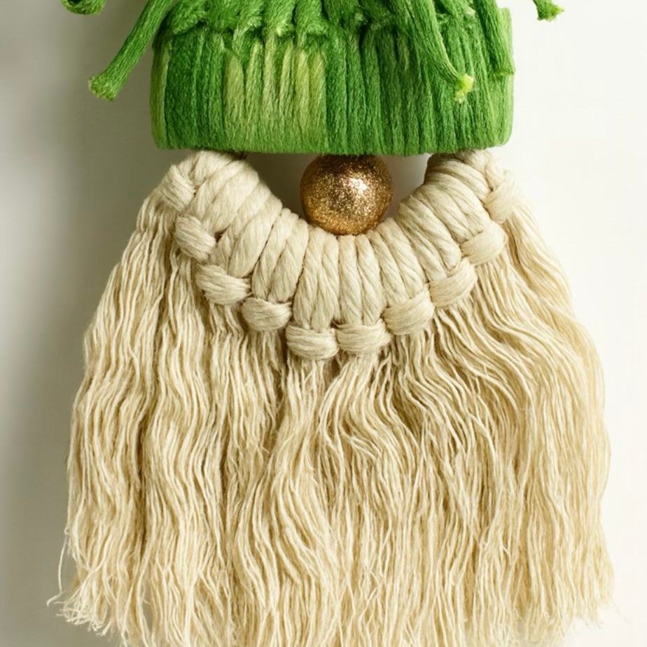 Gnome figurine with green hat and long white beard on a neutral background