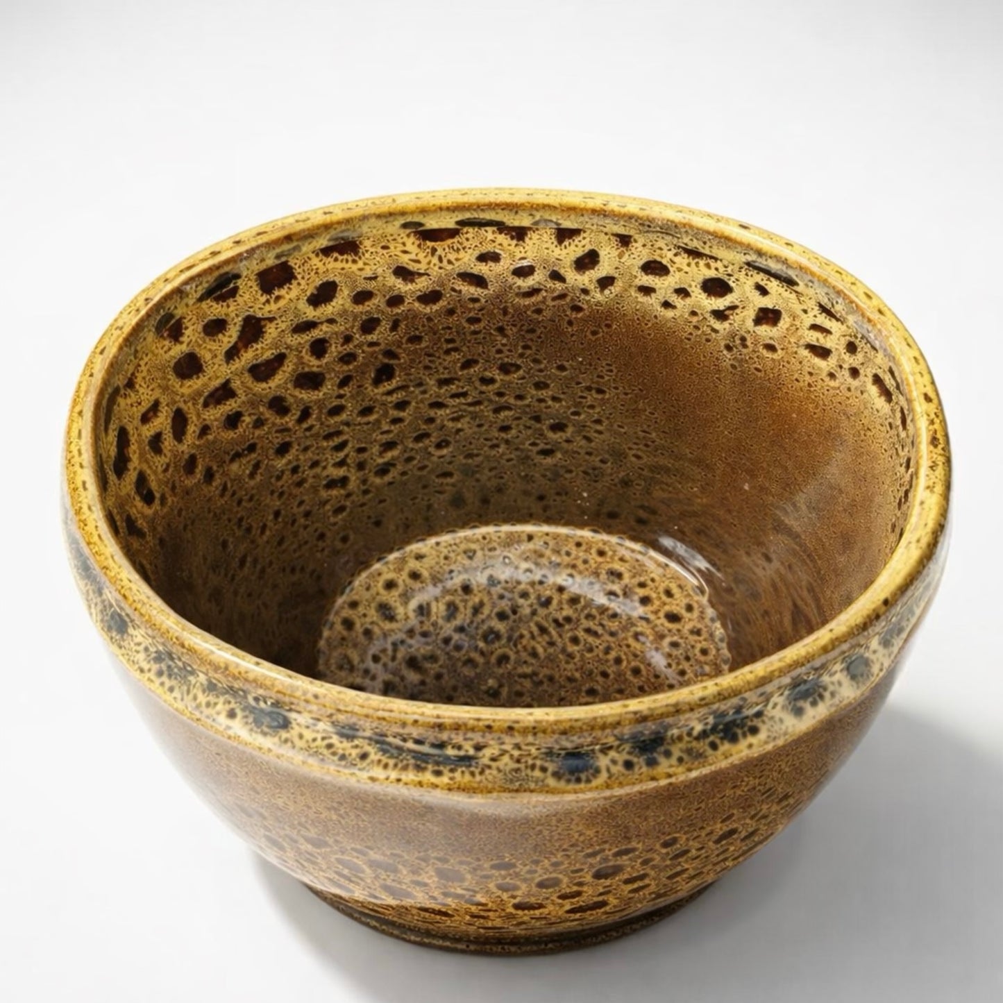 Brown ceramic bowl with textured surface on a white background