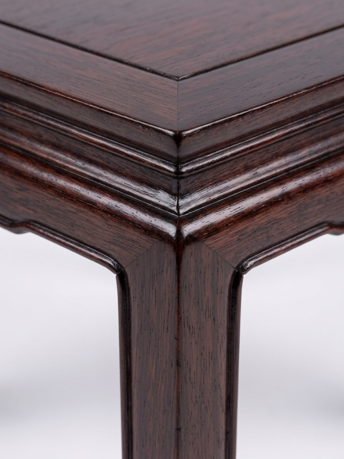 Square dark hardwood Ming-style low table up close corner detail view