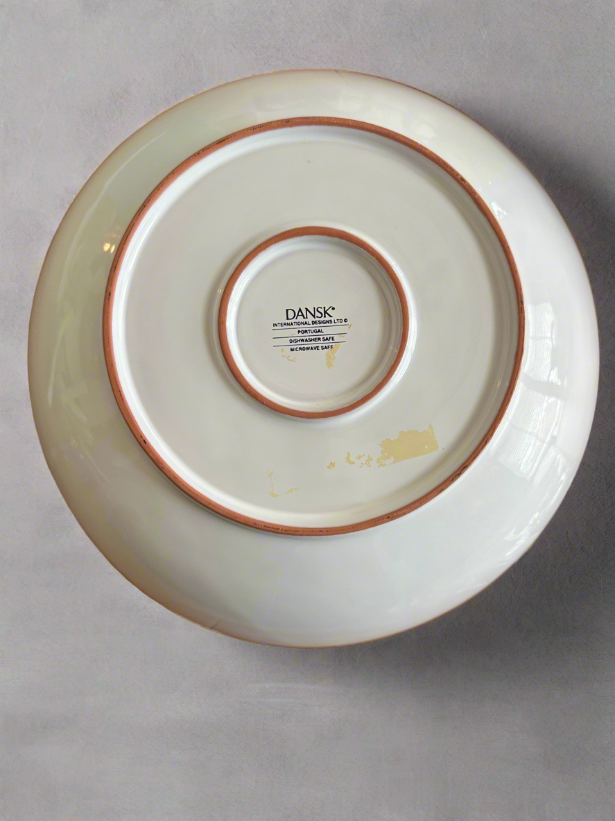 Bottom of Dansk International Designs ceramic dish showing Portugal origin stamp and microwave-safe label, useful for verifying authenticity and provenance