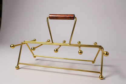 Vintage gold-tone wire drink carrier for eight glasses, showcasing a geometric frame and minimalist space-age design.