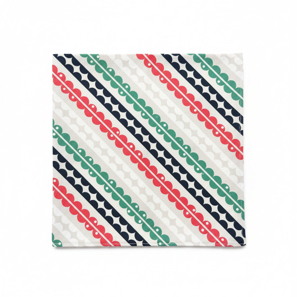 Matilda cloth napkin laid flat showing full repeat of hand-printed mid-century geometric stripe pattern in coral pink, teal, and navy on white cotton, 18 inch square