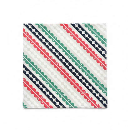 Matilda cloth napkin laid flat showing full repeat of hand-printed mid-century geometric stripe pattern in coral pink, teal, and navy on white cotton, 18 inch square